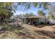 Home's backyard features an outdoor seating area, landscaped lawn, and shade trees at 245 Faithway Dr, Seffner, FL 33584