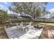 Backyard features patio with an outdoor dining area and a shade tree at 245 Faithway Dr, Seffner, FL 33584