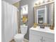 A full bathroom featuring a shower/tub combination, toilet, sink, and decorative mirror at 245 Faithway Dr, Seffner, FL 33584