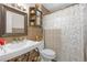 Full bathroom with tile backsplash, decorated mirror, and pedestal sink at 245 Faithway Dr, Seffner, FL 33584