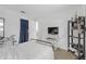 This bedroom has tile floors, a TV, and a black shelving unit at 245 Faithway Dr, Seffner, FL 33584