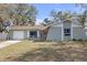 Charming single-story home featuring a welcoming pink front door and a well-maintained lawn at 245 Faithway Dr, Seffner, FL 33584