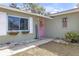 Inviting front exterior with a pink door, beautiful window boxes, and a charming welcome sign at 245 Faithway Dr, Seffner, FL 33584