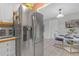 Kitchen shows stainless steel refrigerator and a view into the breakfast nook with table at 245 Faithway Dr, Seffner, FL 33584