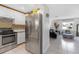 Spacious kitchen featuring stainless steel appliances, white cabinets and opening to the living area at 245 Faithway Dr, Seffner, FL 33584