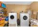 A well-equipped laundry room with a modern washer and dryer, a water heater, and ample storage space at 245 Faithway Dr, Seffner, FL 33584