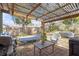 Enclosed patio features a grill, hammock and outdoor seating for backyard enjoyment at 245 Faithway Dr, Seffner, FL 33584