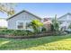 Well-maintained single-story home with lush landscaping and a beautiful stone retaining wall at 2473 Bentley Dr, Palm Harbor, FL 34684