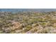 Aerial view of a neighborhood with a home featuring a pool, set amongst lush trees with a bay in the background at 306 Indian Rocks S Rd, Largo, FL 33770