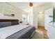 Bedroom featuring a queen bed with a ceiling fan and a large closet providing ample storage at 306 Indian Rocks S Rd, Largo, FL 33770