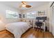Bright bedroom with natural light, features a ceiling fan, a desk, and wood floors at 306 Indian Rocks S Rd, Largo, FL 33770