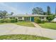 Charming single-story home featuring a well-manicured front lawn and an inviting blue front door at 306 Indian Rocks S Rd, Largo, FL 33770