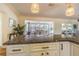 Kitchen island with granite countertops overlooking a dining area with lots of natural light at 306 Indian Rocks S Rd, Largo, FL 33770