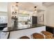 Open kitchen with a granite countertop island, stainless steel appliances, and pendant lighting at 306 Indian Rocks S Rd, Largo, FL 33770