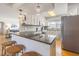 Open-concept kitchen featuring a large island with seating, stainless steel appliances, and pendant lighting at 306 Indian Rocks S Rd, Largo, FL 33770