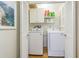 Convenient laundry room with white washer, dryer, storage cabinets, and shelving at 306 Indian Rocks S Rd, Largo, FL 33770