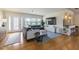 Open-concept living room with wood floors, plenty of light, bar seating, and a large sofa at 306 Indian Rocks S Rd, Largo, FL 33770