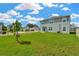 Large backyard showcasing a well-maintained lawn, offering ample space for recreation and outdoor living at 31818 Treasure Dock Isle, Wesley Chapel, FL 33545