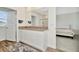 Well-lit bathroom featuring a double sink vanity, with wood floors at 31818 Treasure Dock Isle, Wesley Chapel, FL 33545