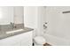 Bathroom features a shower-tub combo and a vanity sink with gray countertops at 31818 Treasure Dock Isle, Wesley Chapel, FL 33545