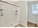 Bright bathroom with a shower with white tile and wood floors at 31818 Treasure Dock Isle, Wesley Chapel, FL 33545