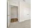 Bedroom with carpet, paneled doors, and a glimpse into a closet/storage area at 31818 Treasure Dock Isle, Wesley Chapel, FL 33545
