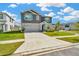 Charming two-story home with a two-car garage, stone veneer, and a well-manicured lawn on a sunny day at 31818 Treasure Dock Isle, Wesley Chapel, FL 33545