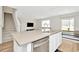 Bright kitchen island with stainless steel dishwasher and a sink, adjoined by a living room at 31818 Treasure Dock Isle, Wesley Chapel, FL 33545