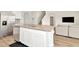 Bright kitchen island with stainless steel dishwasher and a sink, adjoined by a living room at 31818 Treasure Dock Isle, Wesley Chapel, FL 33545