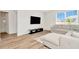 Bright living room with a TV, comfortable sectional sofa, and large windows at 31818 Treasure Dock Isle, Wesley Chapel, FL 33545