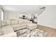 Open-concept living space featuring a sectional sofa, kitchen, and a staircase at 31818 Treasure Dock Isle, Wesley Chapel, FL 33545