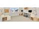 Office features built-in desks, ample storage, and a bright window at 31818 Treasure Dock Isle, Wesley Chapel, FL 33545