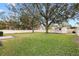 Large backyard with white fence and a shed. Large trees are also visible at 3917 Appletree Dr, Valrico, FL 33594