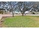 Spacious backyard with mature trees and white perimeter fence for privacy at 3917 Appletree Dr, Valrico, FL 33594