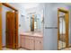 Clean bathroom with light pink vanity, mirrored sliding closet doors and tile flooring at 3917 Appletree Dr, Valrico, FL 33594