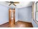 Bedroom showcasing hardwood floors, ceiling fan, window for natural light and blue painted walls at 3917 Appletree Dr, Valrico, FL 33594