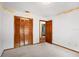 Carpeted bedroom with bi-fold closet doors, a ceiling vent, and access to another room at 3917 Appletree Dr, Valrico, FL 33594