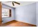Bedroom featuring hardwood floors, ceiling fan, a window for natural light and blue painted walls at 3917 Appletree Dr, Valrico, FL 33594