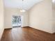 Bright dining room with hardwood floors and sliding glass door leading to the pool at 3917 Appletree Dr, Valrico, FL 33594