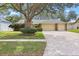 Charming single-Gathering home with a three-car garage and well-manicured landscaping at 3917 Appletree Dr, Valrico, FL 33594