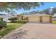 Well-maintained home with a spacious driveway leading to a two-car garage at 3917 Appletree Dr, Valrico, FL 33594