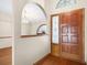 Welcoming foyer featuring hardwood floors and a decorative front door at 3917 Appletree Dr, Valrico, FL 33594