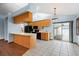 Bright kitchen features wood cabinets, black appliances, and an eat-in breakfast bar with a large sliding door at 3917 Appletree Dr, Valrico, FL 33594