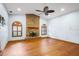 Spacious living room featuring a brick fireplace, hardwood floors, and blue walls at 3917 Appletree Dr, Valrico, FL 33594