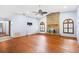 Large living room with hardwood floors, brick fireplace, and modern ceiling fan at 3917 Appletree Dr, Valrico, FL 33594