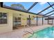 Screened in pool with brick deck and view of sliding glass doors leading indoors at 3917 Appletree Dr, Valrico, FL 33594