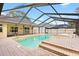 Outdoor pool area with a screened-in enclosure, hot tub and brick paved deck at 3917 Appletree Dr, Valrico, FL 33594