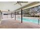 Outdoor pool area with a screened-in enclosure, covered patio, and brick paved deck at 3917 Appletree Dr, Valrico, FL 33594