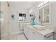 Modern bathroom with double vanity sinks, elegant mirrors, and a walk-in shower at 3961 12Th Ne St, St Petersburg, FL 33703