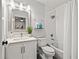 Well-lit bathroom featuring a shower-tub combo, modern vanity, and neutral color scheme at 3961 12Th Ne St, St Petersburg, FL 33703